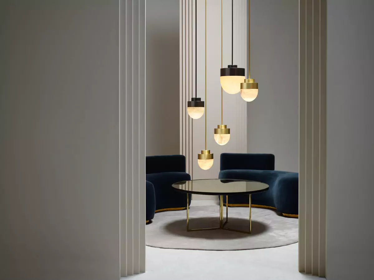 A modern living room featuring a round table and four stylish pendant lights, showcasing innovative interior design ideas.